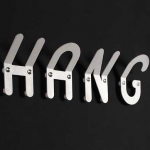 Wall hooks spell out the word :HANG"
