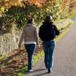 two young women walking along a country road