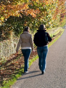 two young women walking along a country road