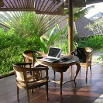 Indonesian veranda with table, chairs and laptop