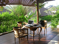 Indonesian veranda with table, chairs and laptop