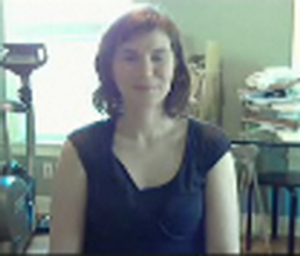 video conference view of woman in messy home office