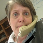 Startled woman on telephone