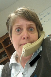 Startled woman on telephone