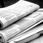 B & W photo stack of newspapers