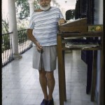 photo of ernest hemingway on a Cuban veranda, standing next to his standing desk