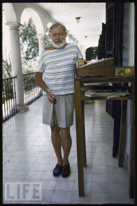 photo of ernest hemingway on a Cuban veranda, standing next to his standing desk