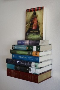 umbra's invisible book shelf Books in a stack appear attached to the wall