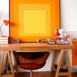 home office with mid-century modern orange chair and abstract painting