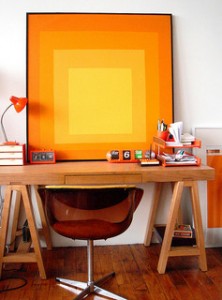 home office with mid-century modern orange chair and abstract painting