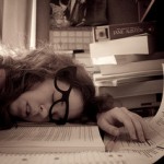 woman slumped on desk, asleep