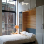 a murphy bed, wall bed makes a home office into a guest room