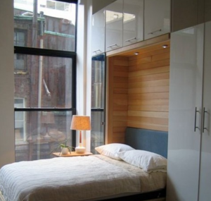 a murphy bed, wall bed makes a home office into a guest room