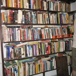 overflowing home office bookshelf