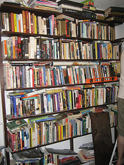 overflowing home office bookshelf